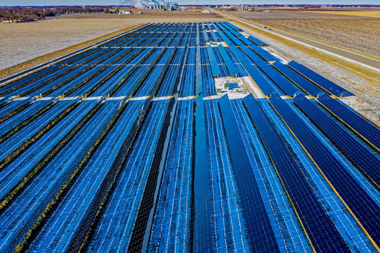Contact Expansive aerial view of solar panels in Claremont, MN, highlighting renewable energy.